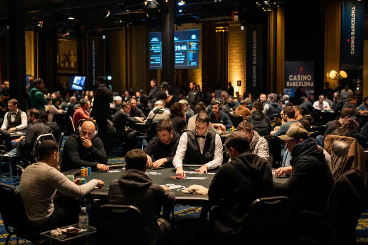 EPT Barcelona tournament floor — Casino Barcelona main room packed with players at green felt tables under golden spotlights