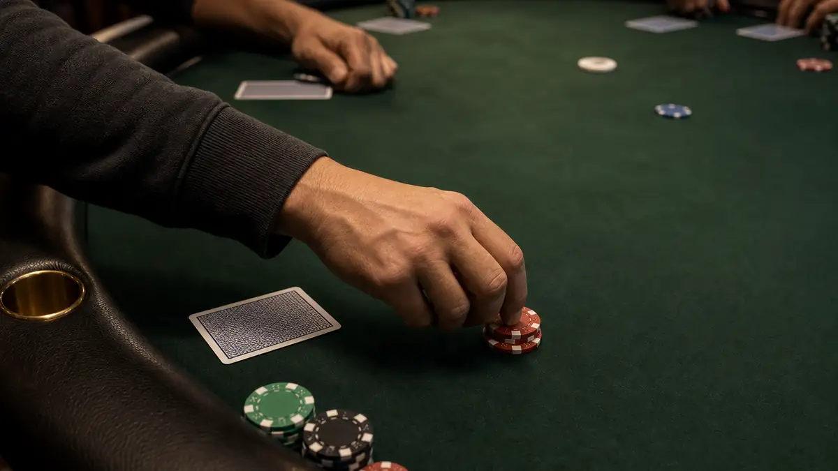 An under-the-gun player posting an extra blind bet of two chips in front of the big blind before the cards are dealt