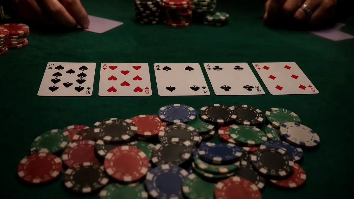 A coordinated flush-heavy board with a paired card and chips pushed forward, the kind of spot where a completing card can still lose